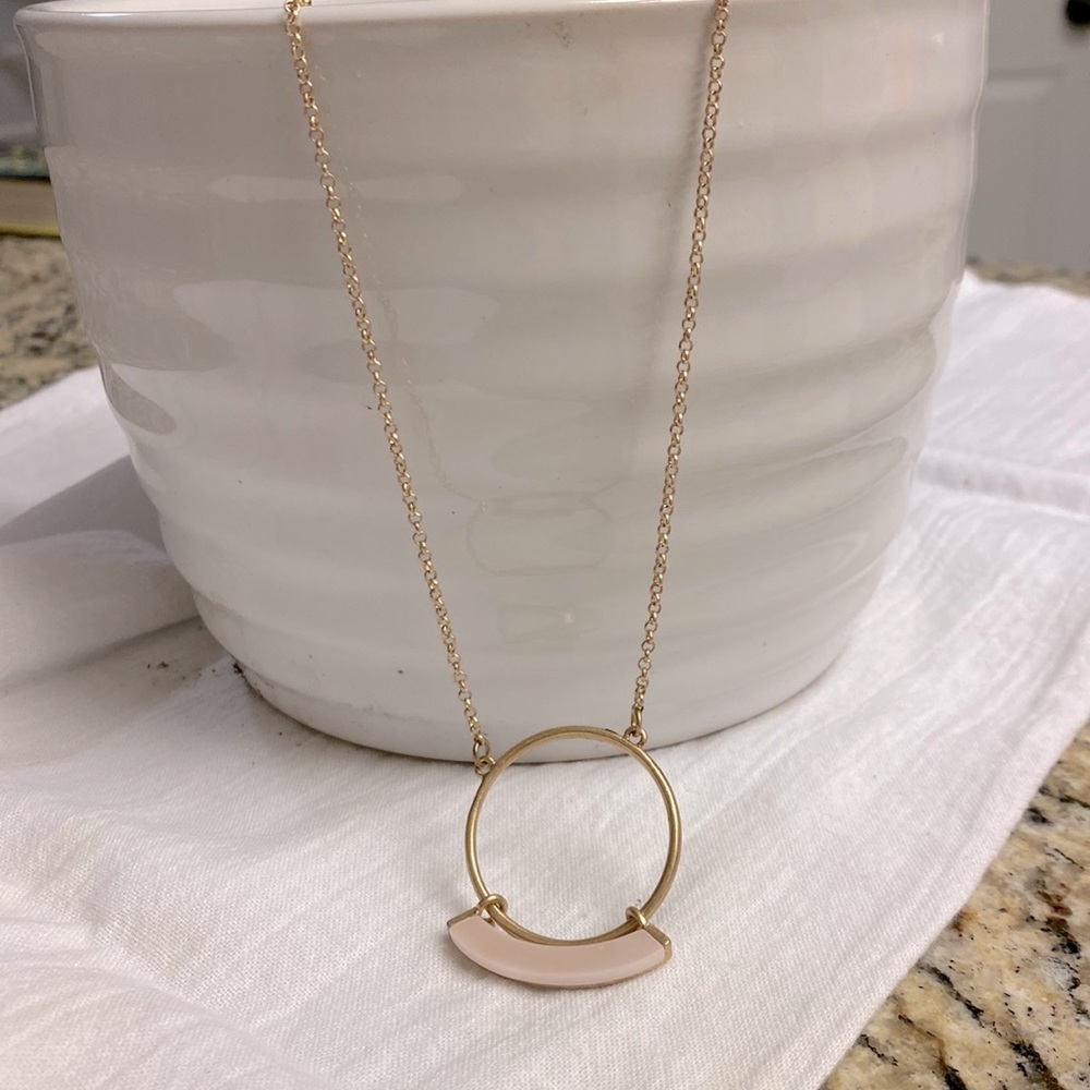 Long necklace with rose pink detail.